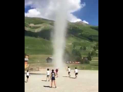 صبية يلعبون مع إعصار يمتد من الأرض للسماء